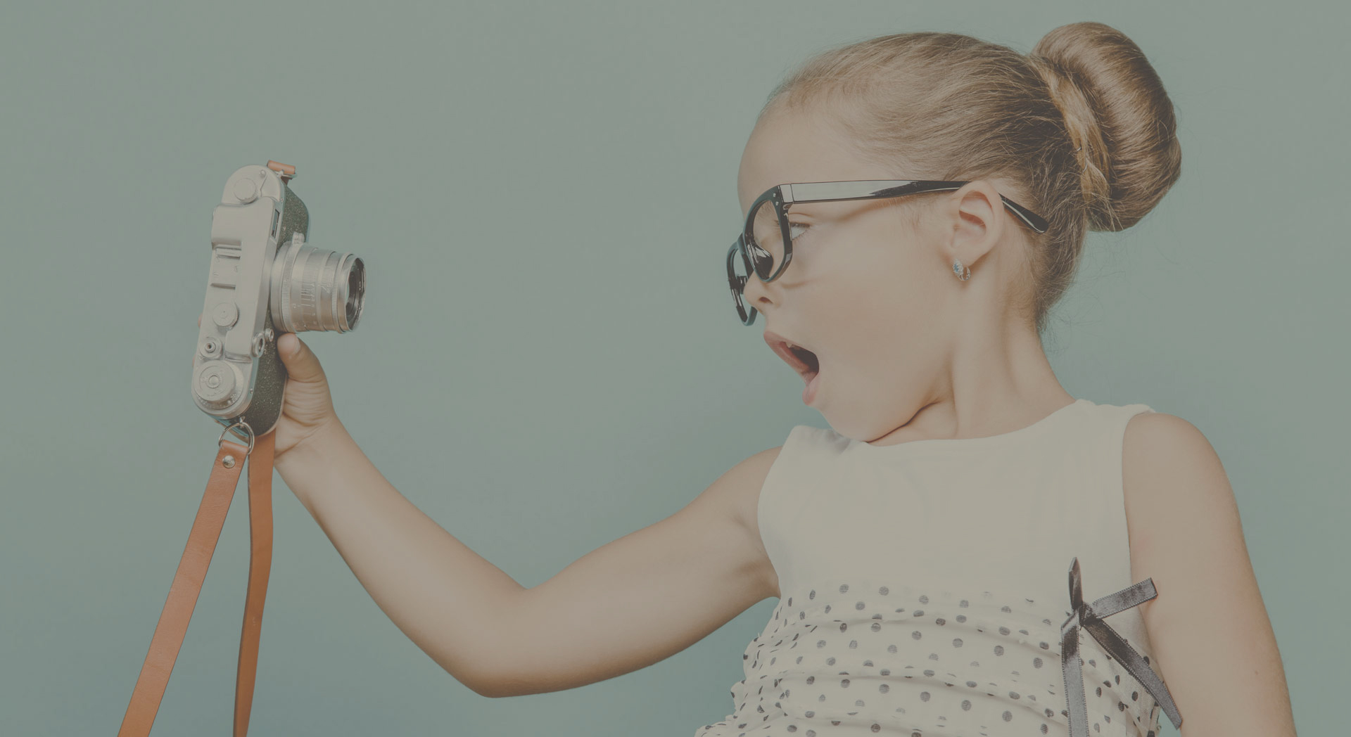 child holding a instant camera